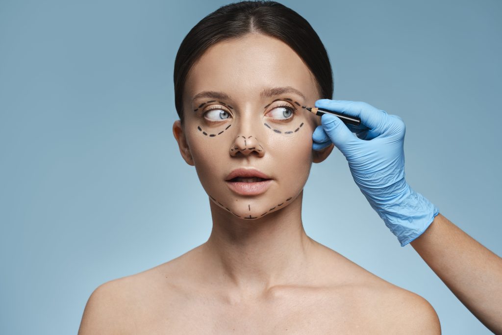 Cosmetic surgeon performing eyelid surgery (blepharoplasty) on a patient to reduce droopy eyelids and under-eye bags in Kolkata