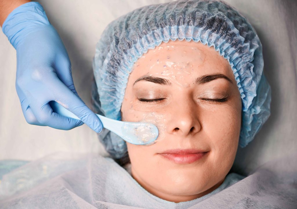 Dermatologist applying chemical peel mask for acne scar removal treatment in Kolkata